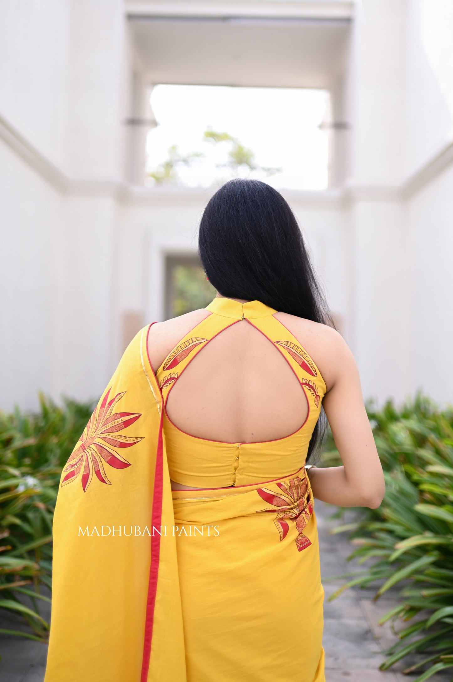 Yellow saree draped, showing the hand-painted aanchal