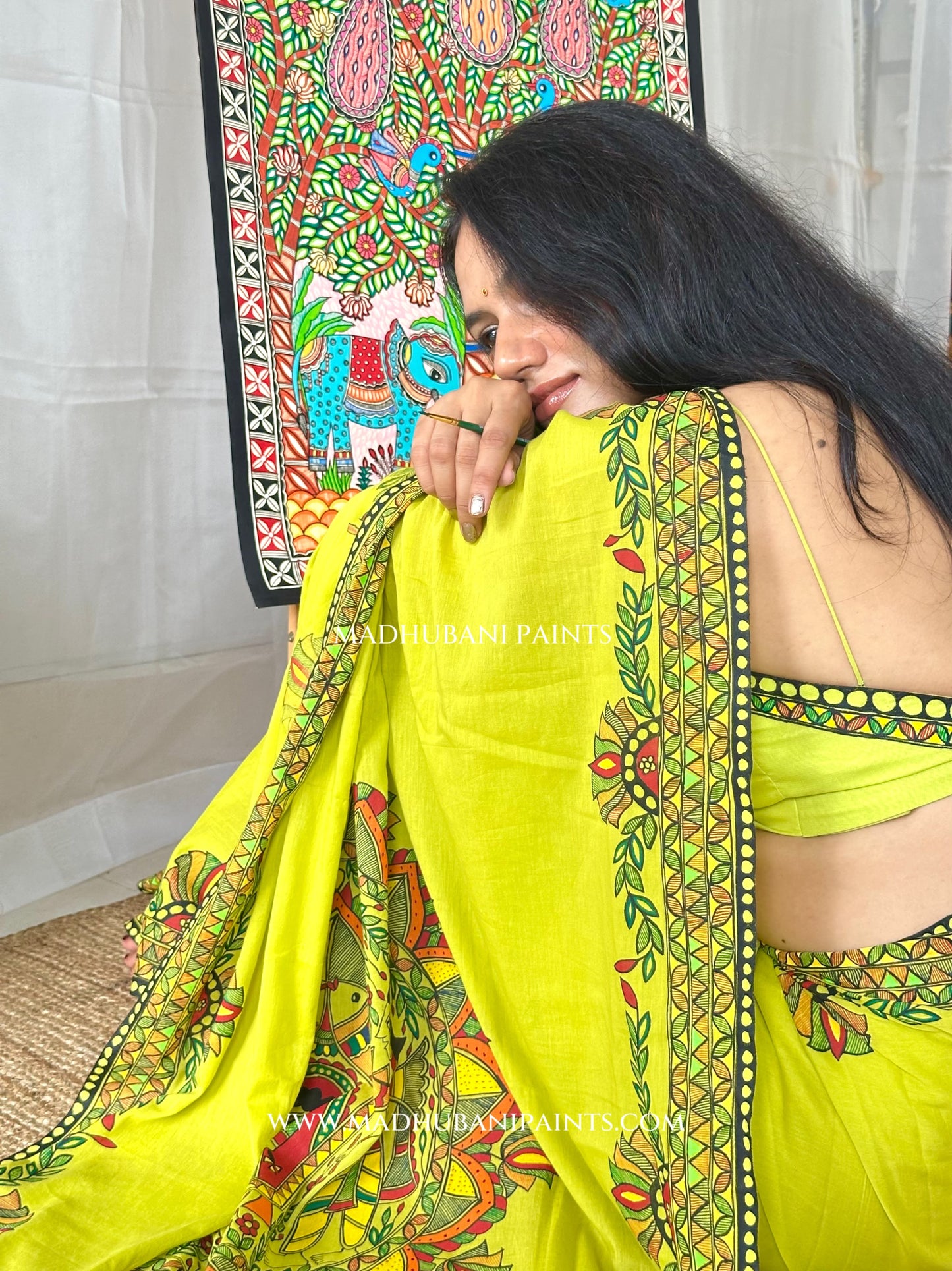 Green saree with matching blouse piece draped, showing the hand-painted aanchal
