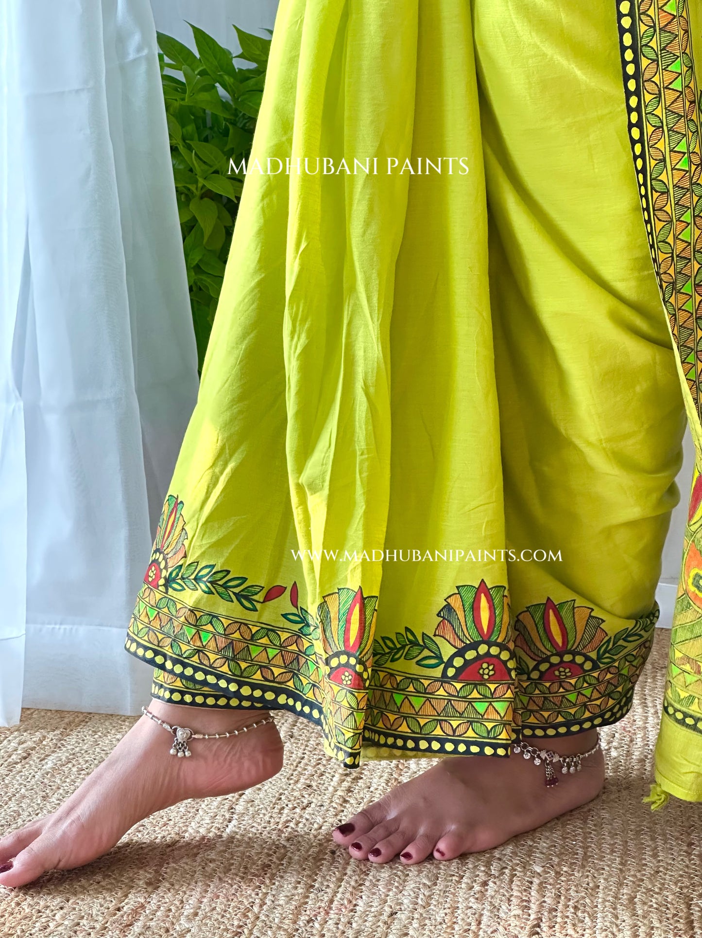 Close-up of a person wearing Green cotton saree with hand-painted Madhubani kamal (lotus) motifs — Hara Shringar