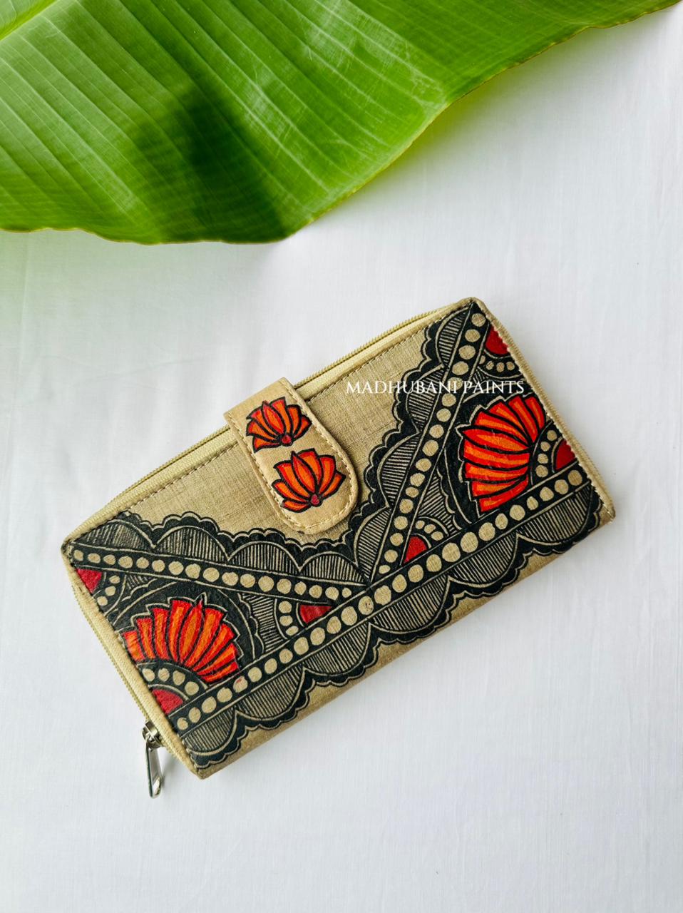 Hand-painted Madhubani clutch in turquoise with a bold diagonal triangle pattern and two lotus, a matching lotus motif on the tab closure