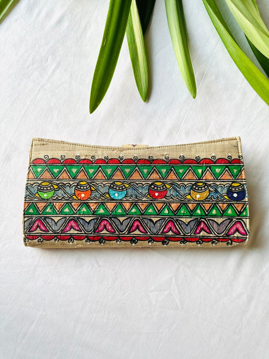 back side of Hand-painted Madhubani clutch in beige with a row of small colorful pots on a wave pattern, framed by green triangle borders.
