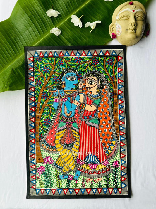 Madhubani painting of Krishna playing the flute beside Radha carrying a water pot, beneath a green leafy canopy with a lotus border below