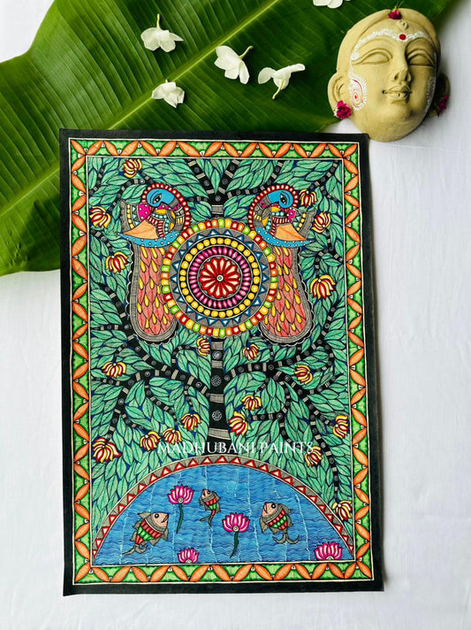 A framed Madhubani painting featuring a tree of life with peacocks, pink lotus flowers, and fish, styled on a white handmade paper