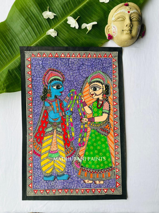 A framed Madhubani painting depicting Ram Sita on a purple background exchanging Garland