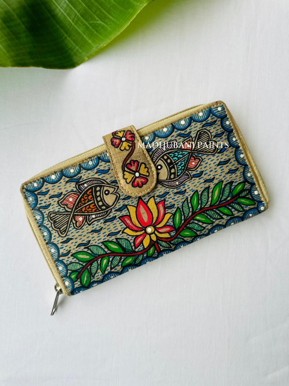 Hand-painted Madhubani clutch in turquoise with two fish facing a central lotus flower, painted water bubbles