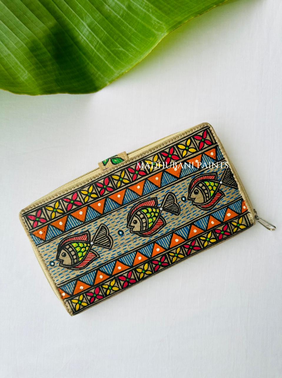 Hand-painted Madhubani clutch in fish swimming in waves , painted water bubbles, and a orange triangle and floral  border along the base