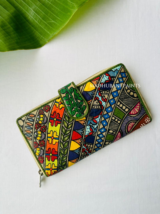 A colorful zip-around wallet decorated with intricate hand-painted tribal patterns in green, yellow, red, blue color