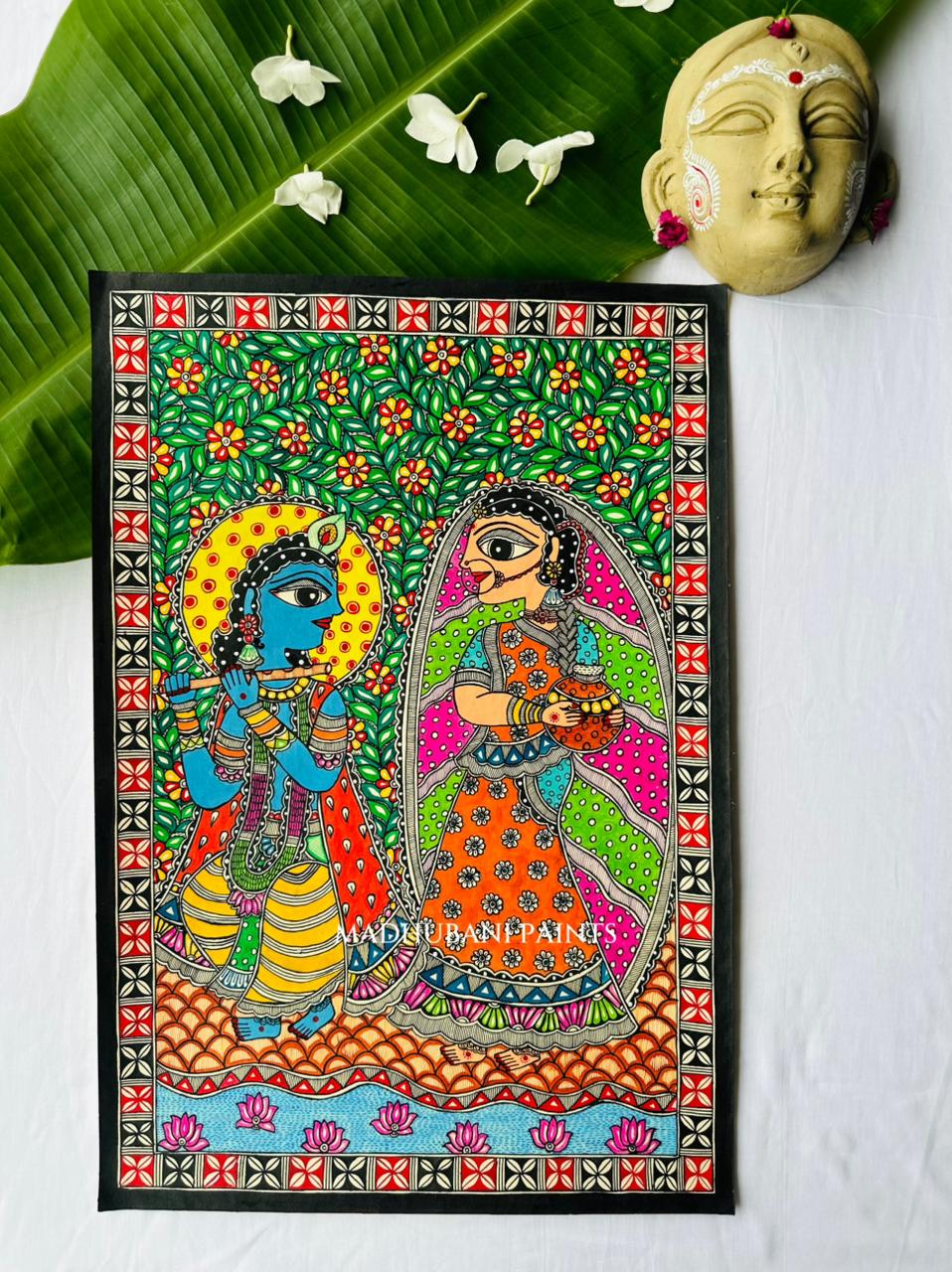 A colorful Madhubani hand-painted folk art print depicting Lord Krishna and Radha