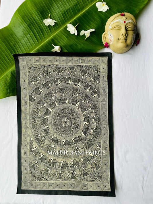 Madhubani mandala painting in black ink on natural cream cloth, concentric rings of tiny repeating figures radiating from a central flower