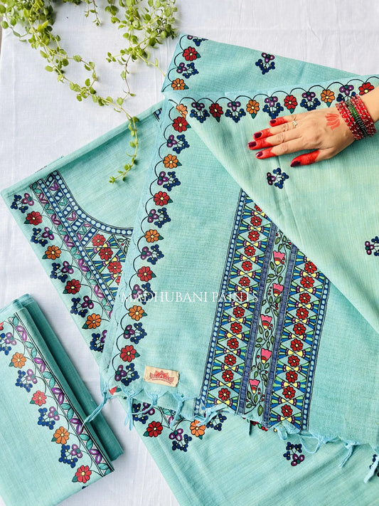 A mint green handpainted salwar suit set, featuring a kurta with colorful floral madhubani artwork, matching trousers, and a dupatta. 