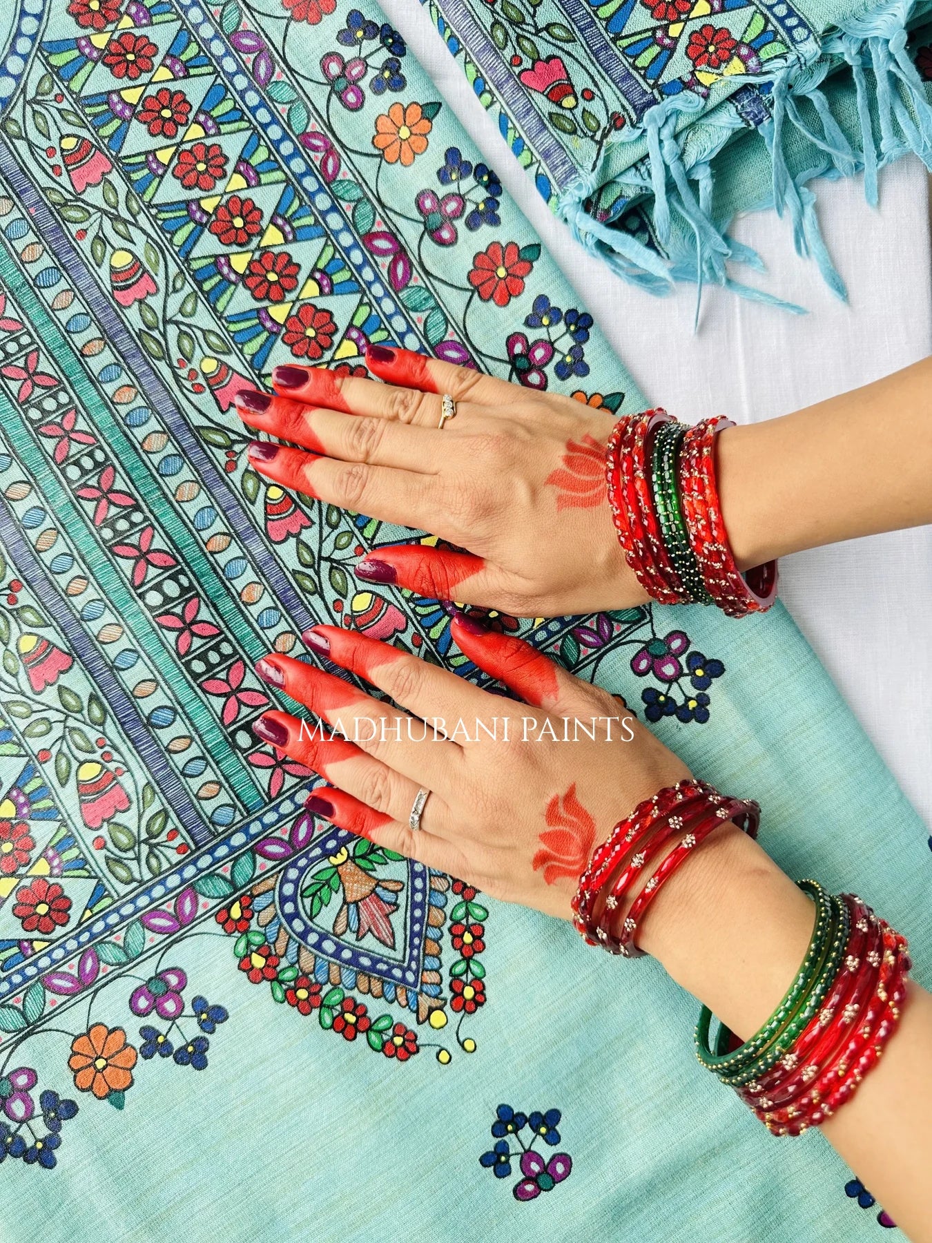 A close-up of a unstitched kurta with intricate madhubani  handpainting