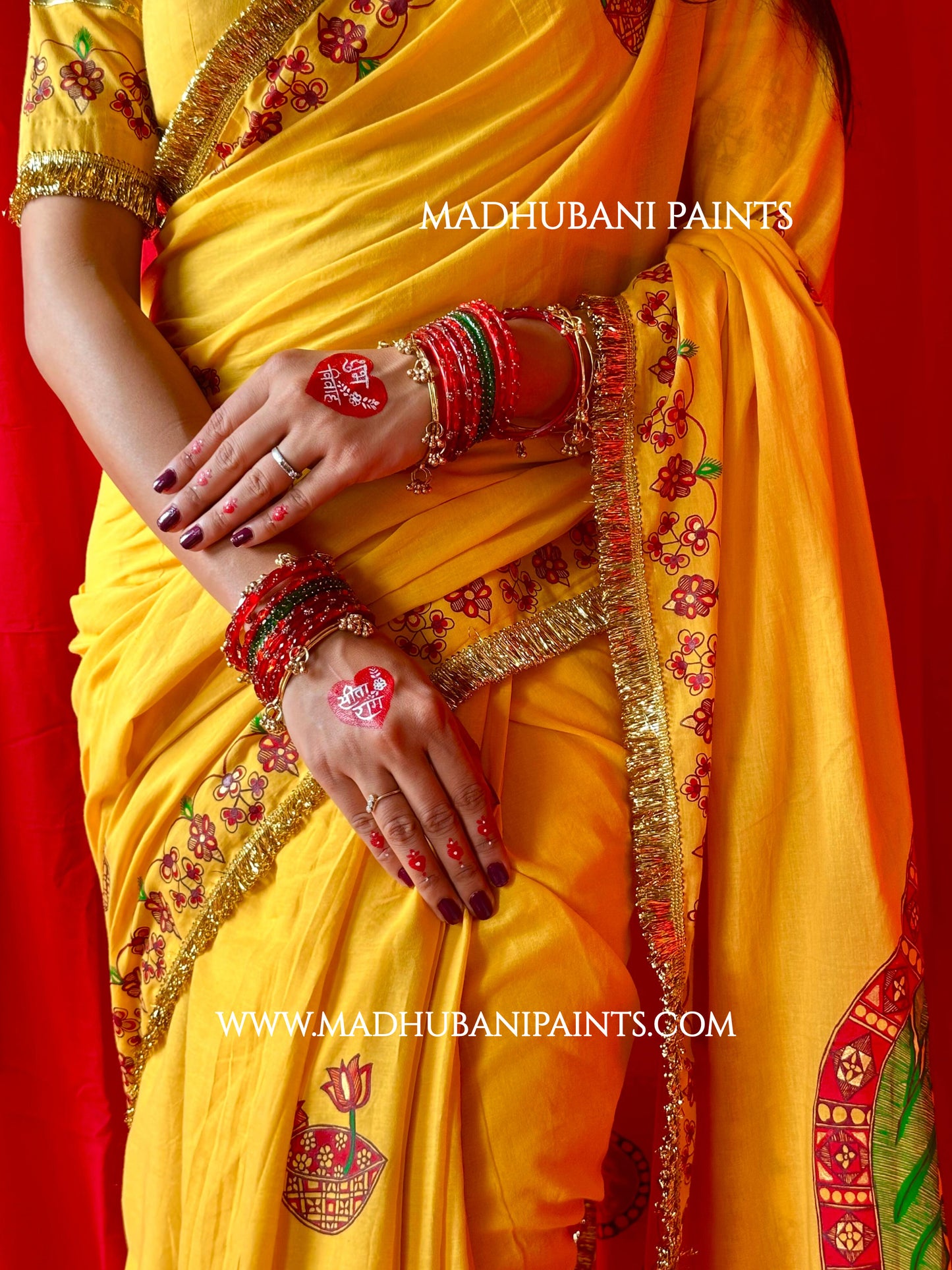 Yellow saree with floral patterns and ram Sita artwork on aanchal, featuring Madhubani Painting