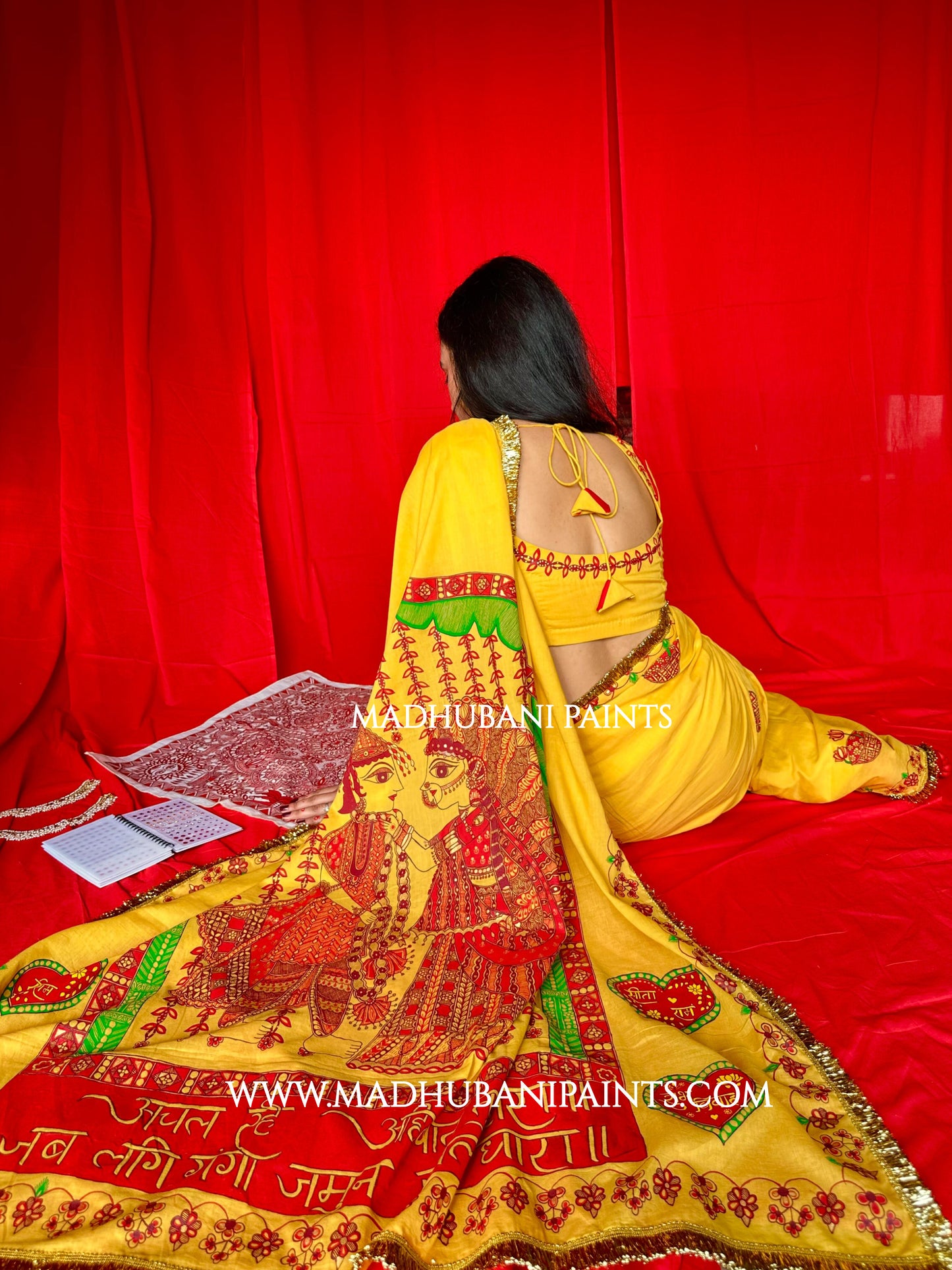 Yellow saree draped, showing the hand-painted aanchal
