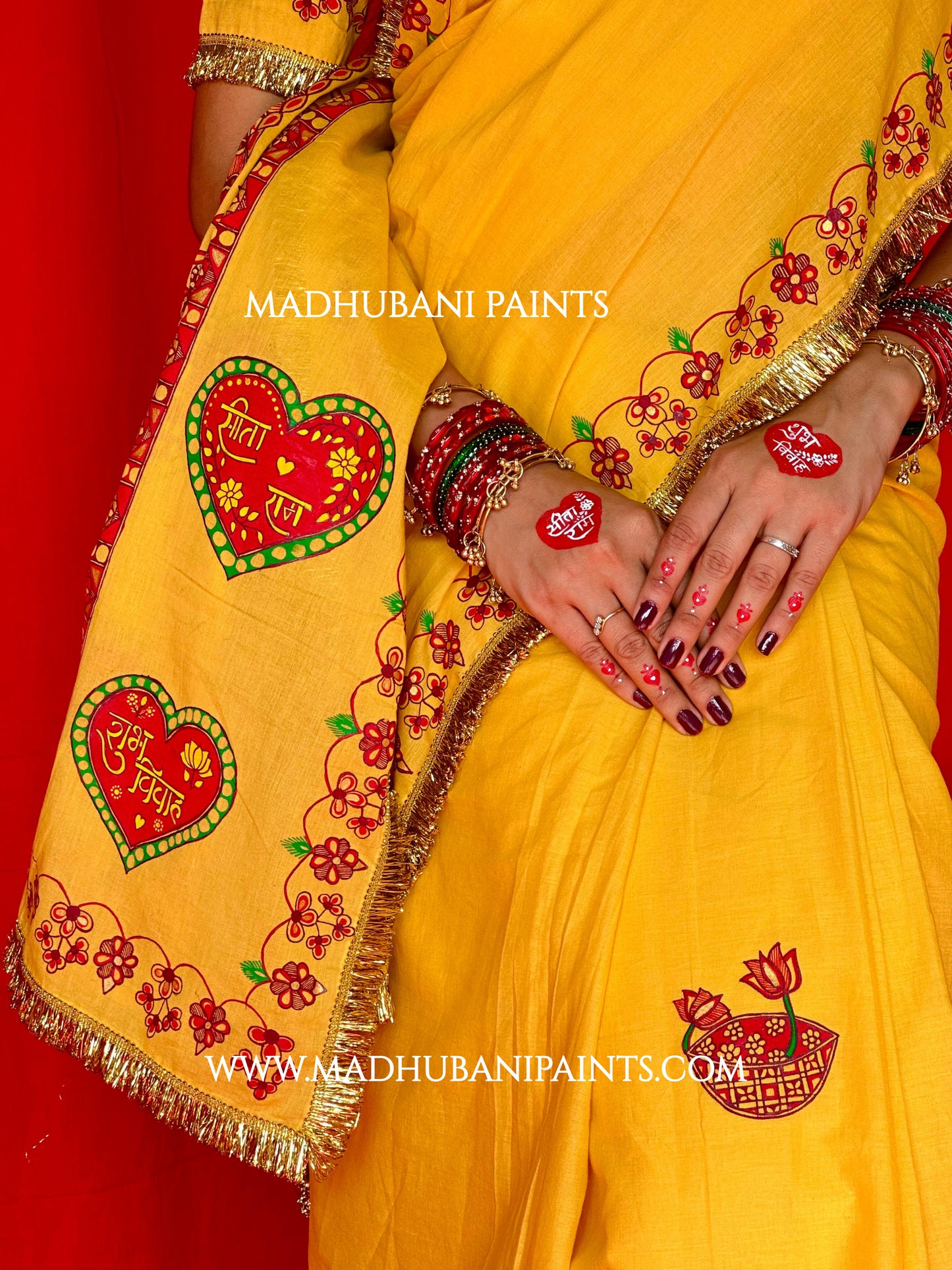 Yellow saree draped, showing the hand-painted aanchal