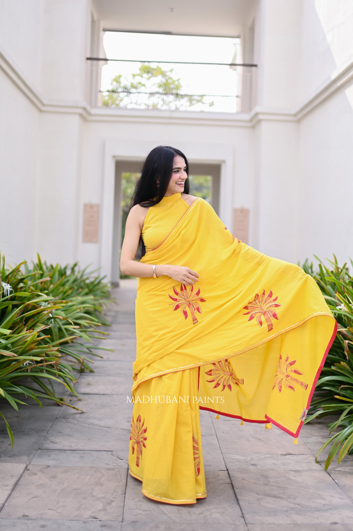 Woman in a yellow saree with handpainted motif