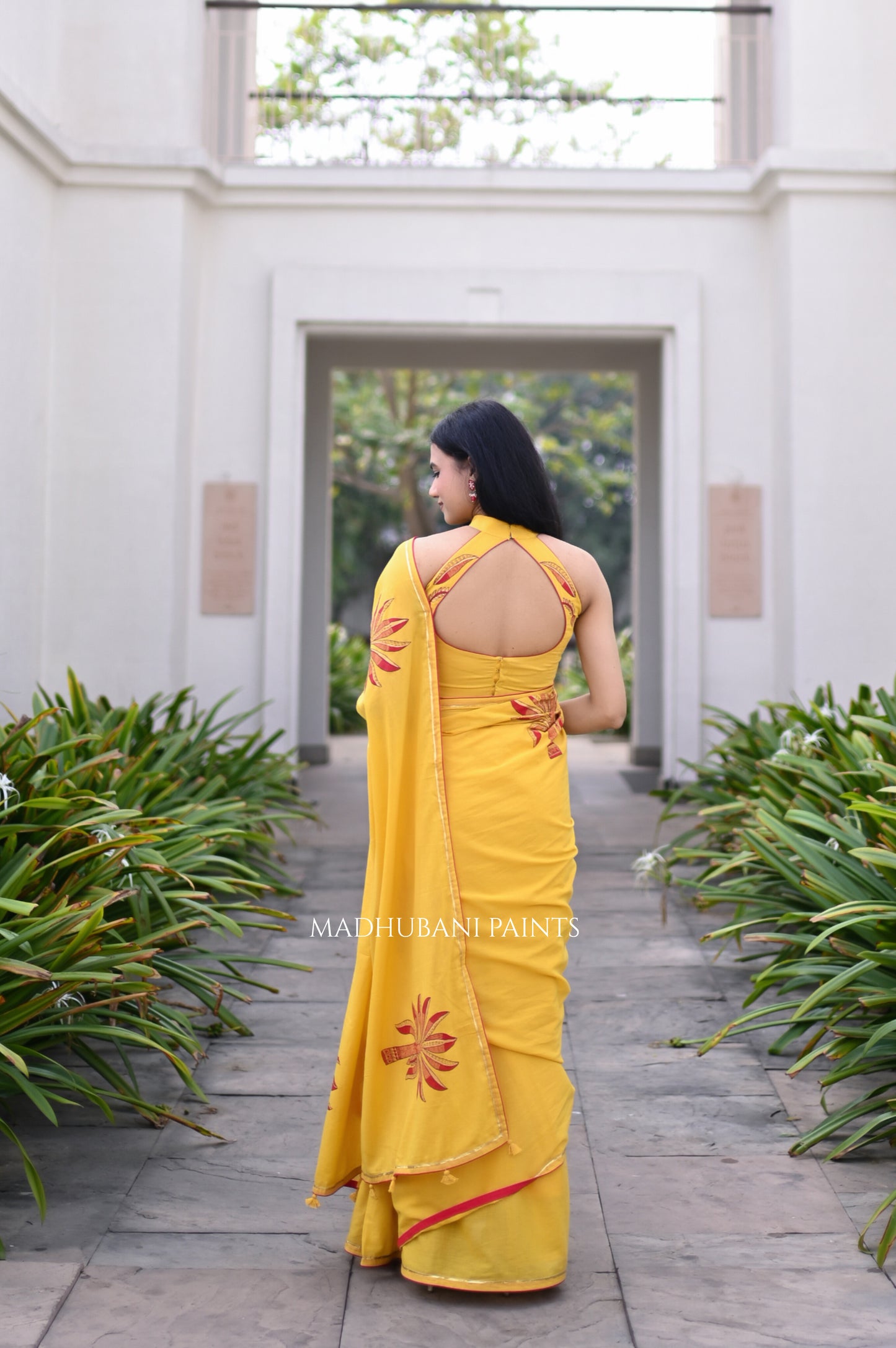 Yellow saree draped, showing the hand-painted aanchal