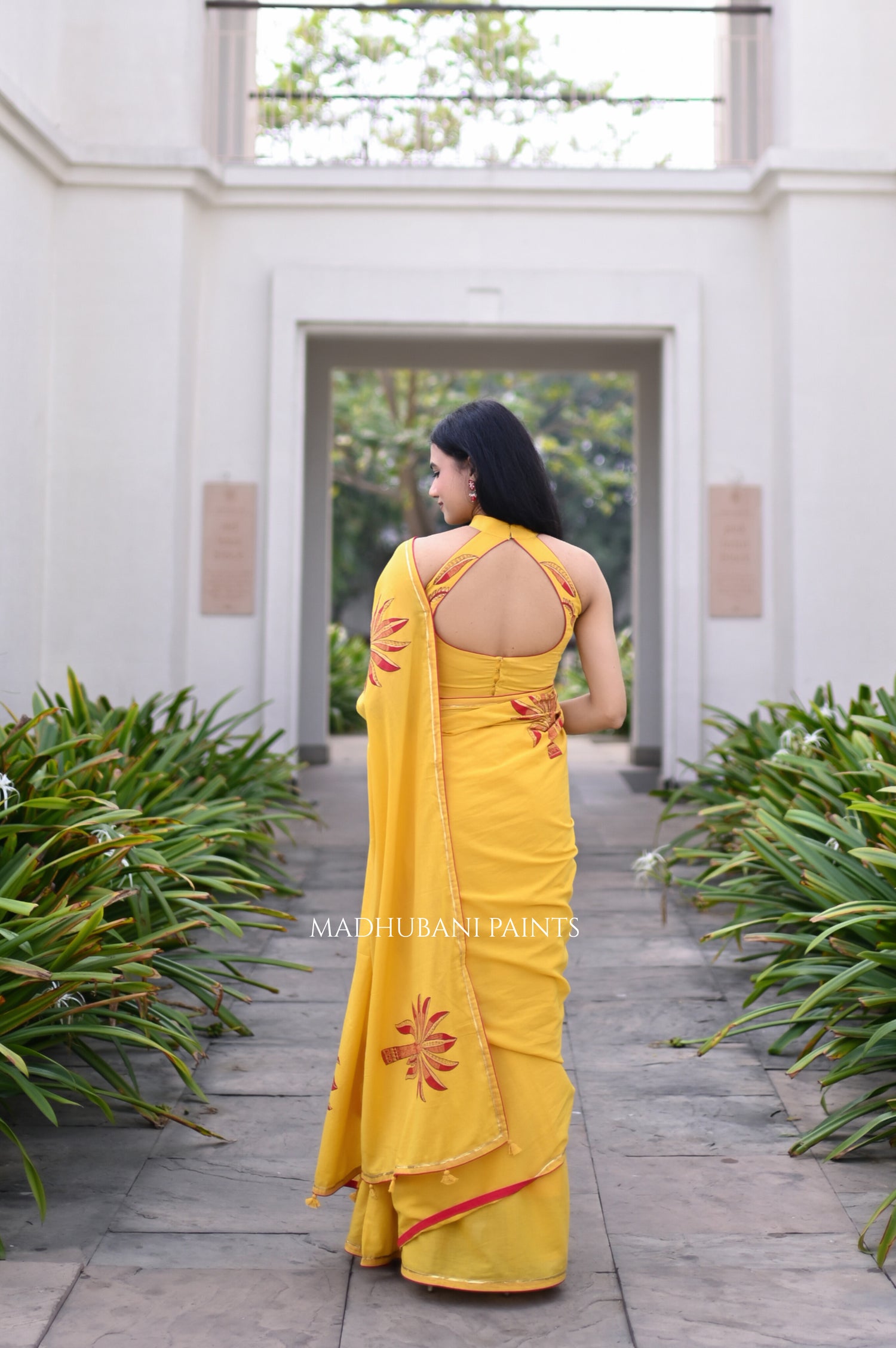 Yellow saree draped, showing the hand-painted aanchal