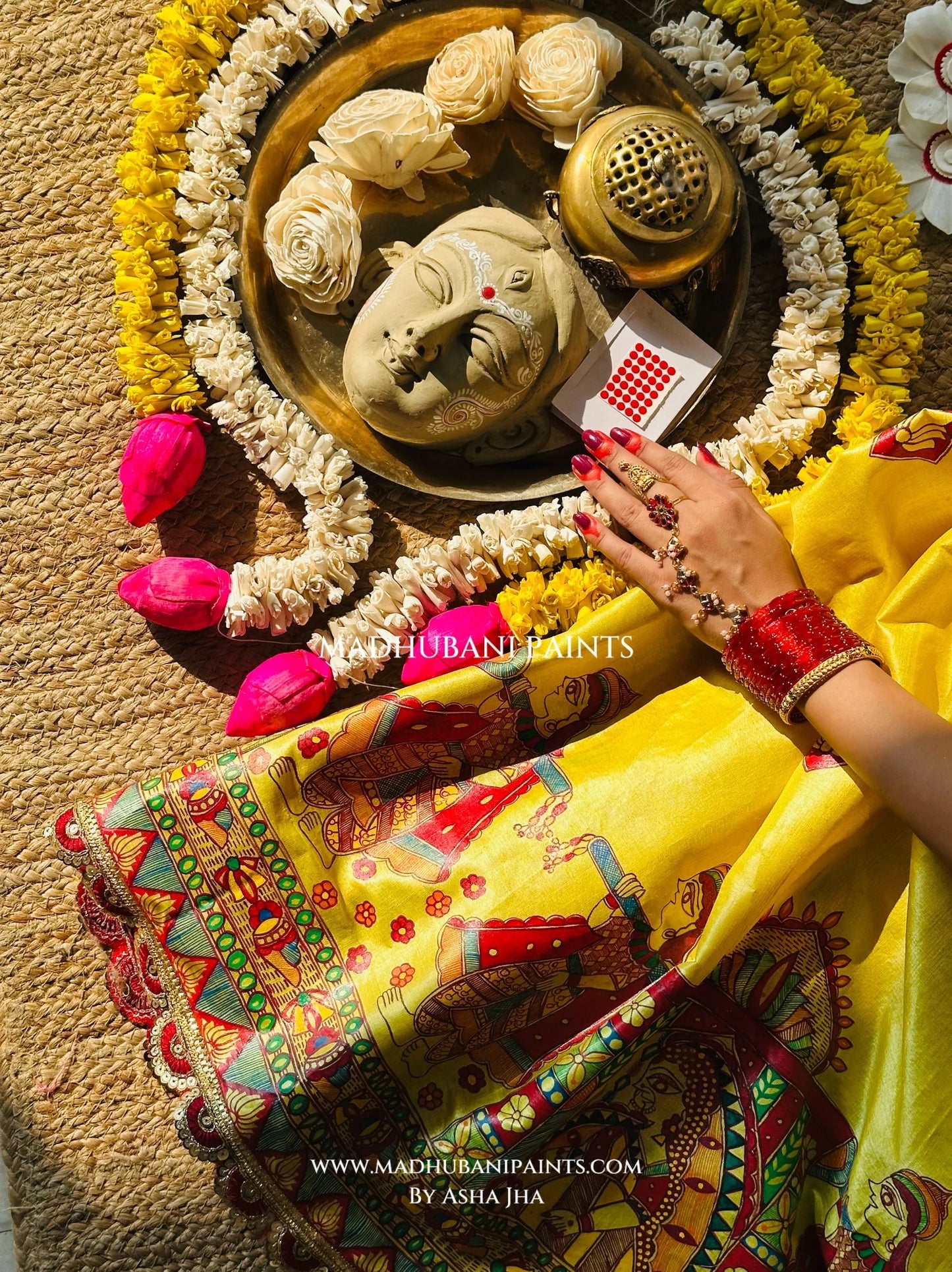 Festive styling of Devi Ki Sawari Madhubani saree with traditional alta, anklets and intricately painted lotus border.