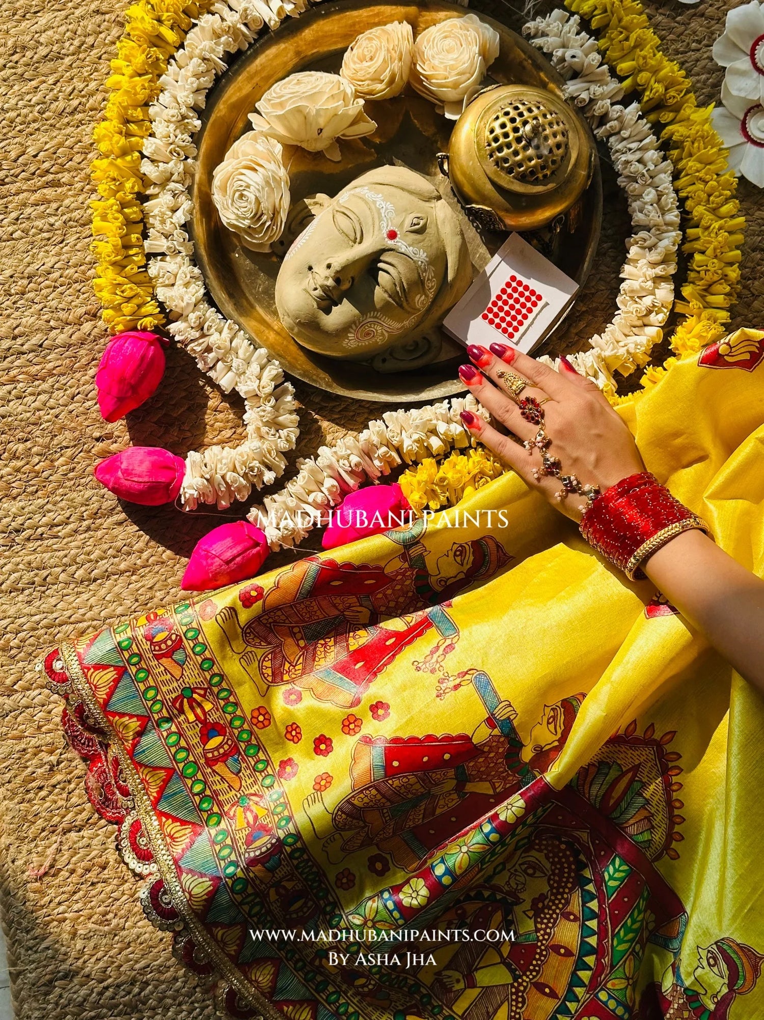 Festive styling of Devi Ki Sawari Madhubani saree with traditional alta, anklets and intricately painted lotus border.