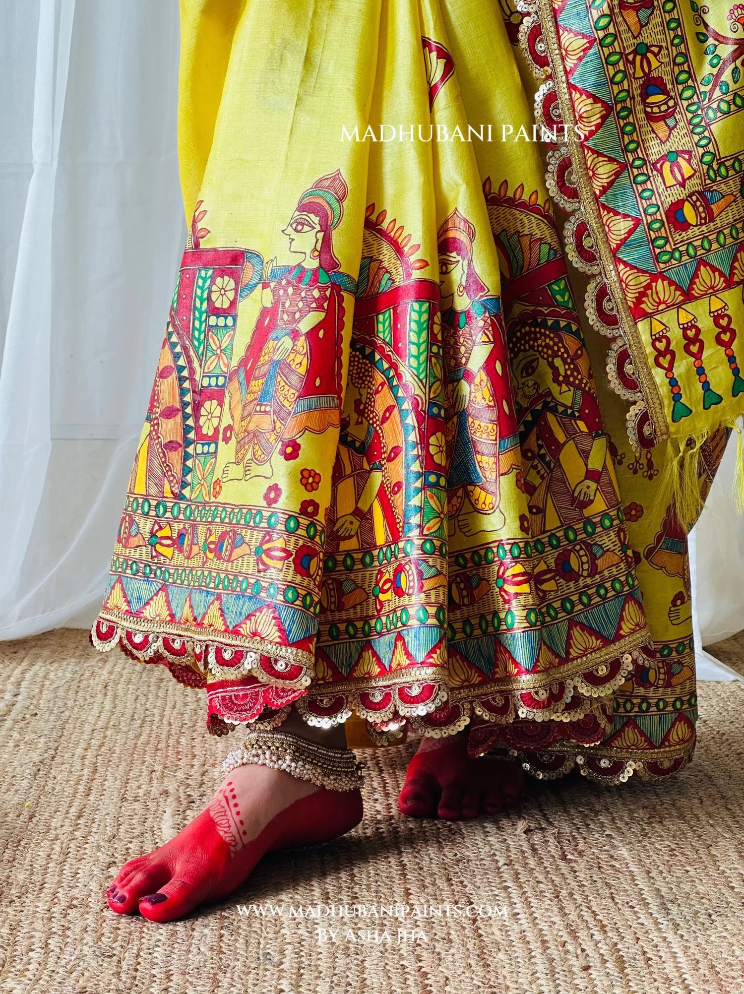 Full view of Devi Ki Sawari yellow saree featuring hand-painted Goddess Durga, peacock, flowering branches and vibrant Madhubani borders.
