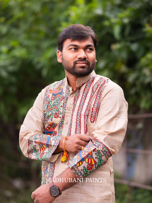 Bengali groom in a traditional hand-painted Madhubani wedding kurta on beige Tussar silk, celebrating Bengali wedding rituals.