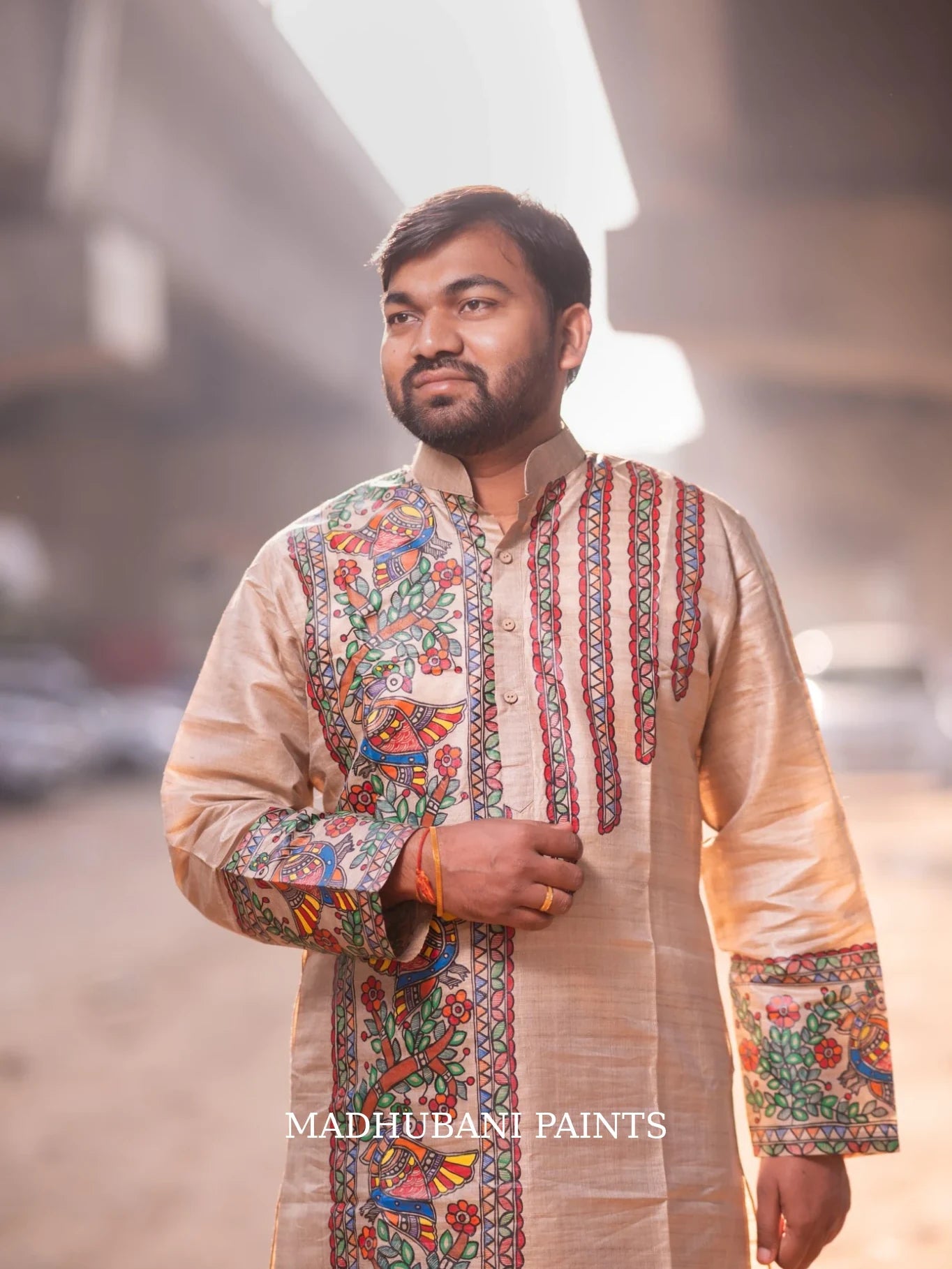 Bengali groom wearing a customized beige Tussar silk kurta featuring intricate hand-painted Madhubani motifs, crafted by Mithila artisans for his wedding