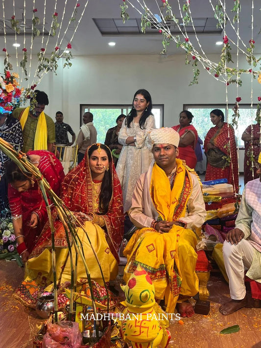 Indian groom wearing a beige Tussar silk Madhubani hand-painted wedding kurta with traditional Mithila motifs during his wedding ceremony