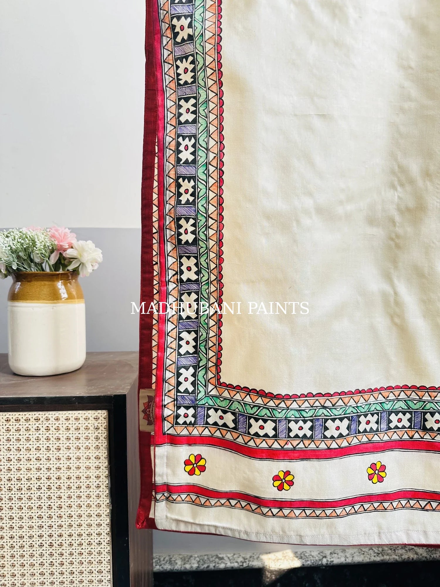 Beige silk stole featuring multi-coloured hand-painted flower motifs and intricate Madhubani-style borders, handcrafted in traditional Mithila painting art.