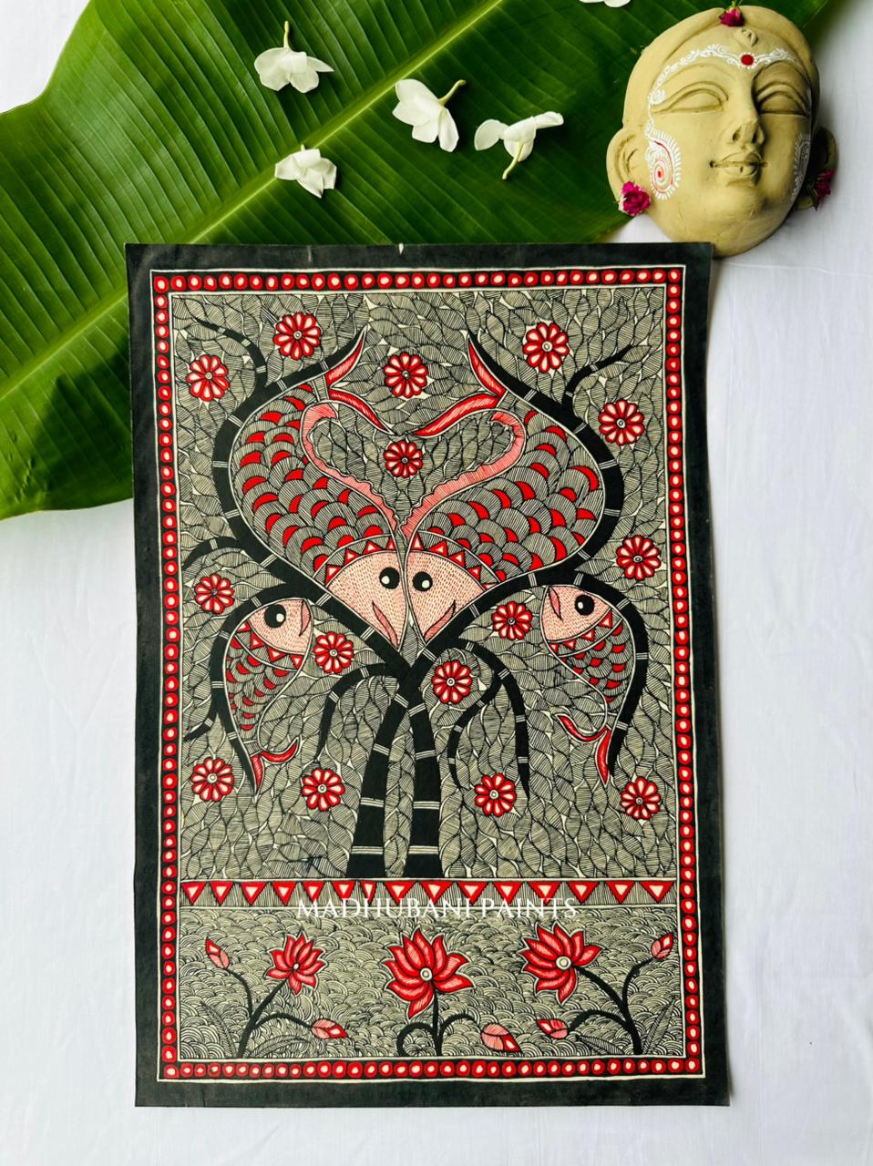 A rectangular hand-painted madhubani folk art canvas featuring two madhubani fish with red and black details
