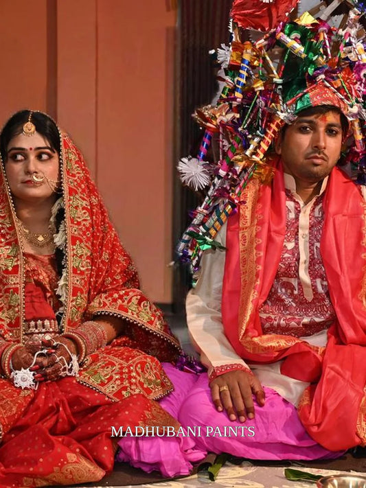 Bihari groom wearing a beige hand-painted Madhubani kurta featuring traditional red and maroon Mithila artwork for his wedding