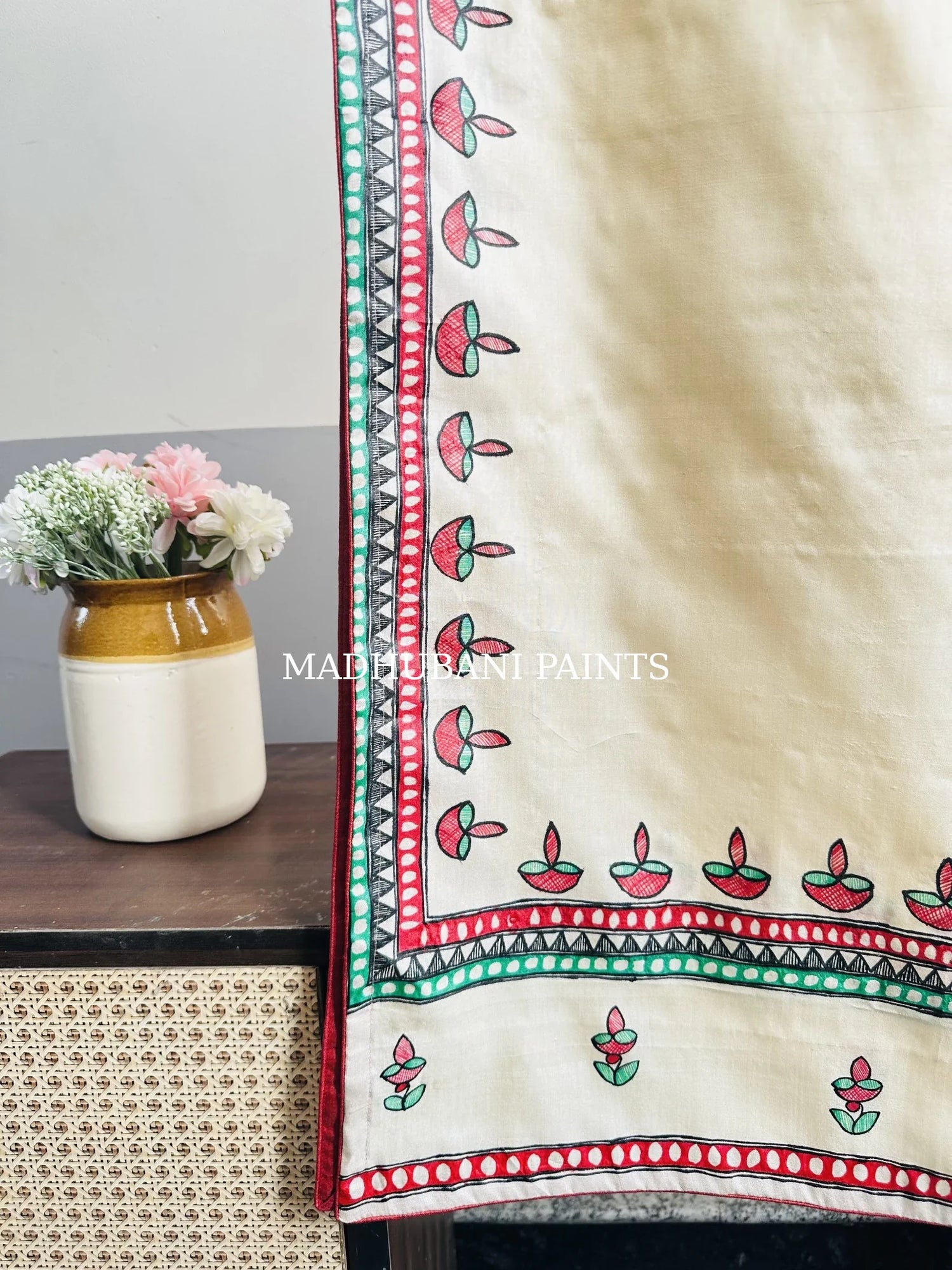 Beige silk stole featuring colorful hand-painted diya motifs and intricate Madhubani-style borders, handcrafted in traditional Mithila painting art.