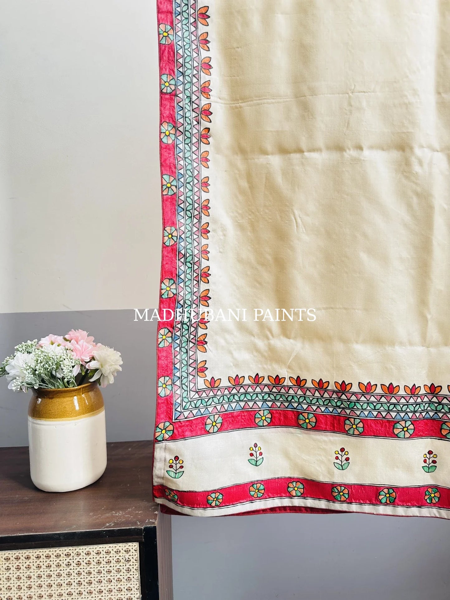 Beige silk stole featuring colorful hand-painted diya motifs and intricate Madhubani-style borders, handcrafted in traditional Mithila painting art.