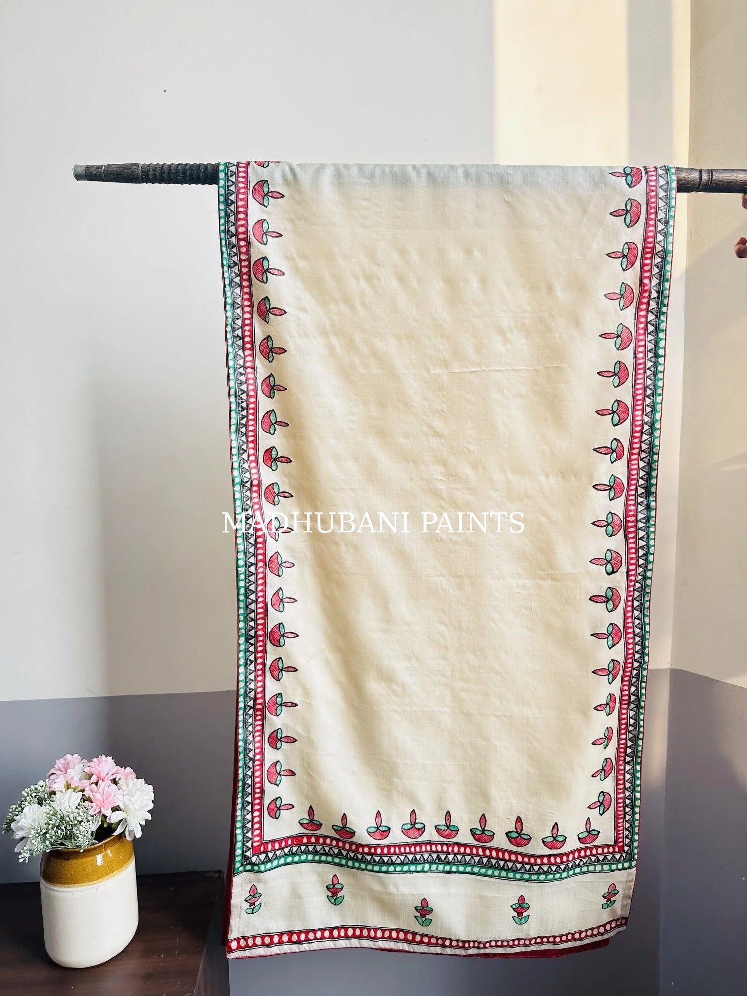 Beige silk stole featuring colorful hand-painted diya motifs and intricate Madhubani-style borders, handcrafted in traditional Mithila painting art.