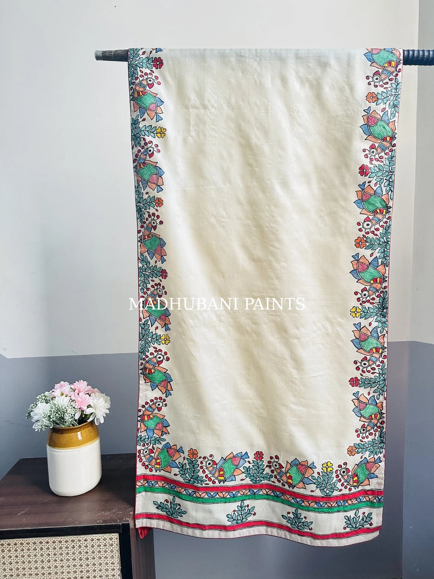 An off-white cotton stoles with colorful hand-painted peacock borders in madhubani painting art