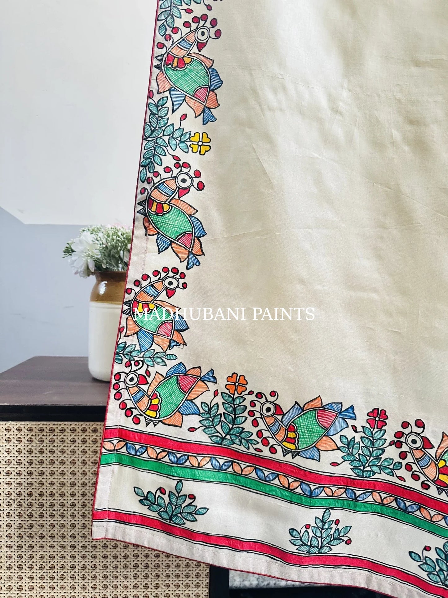 An off-white cotton stoles with colorful hand-painted peacock borders in madhubani painting art