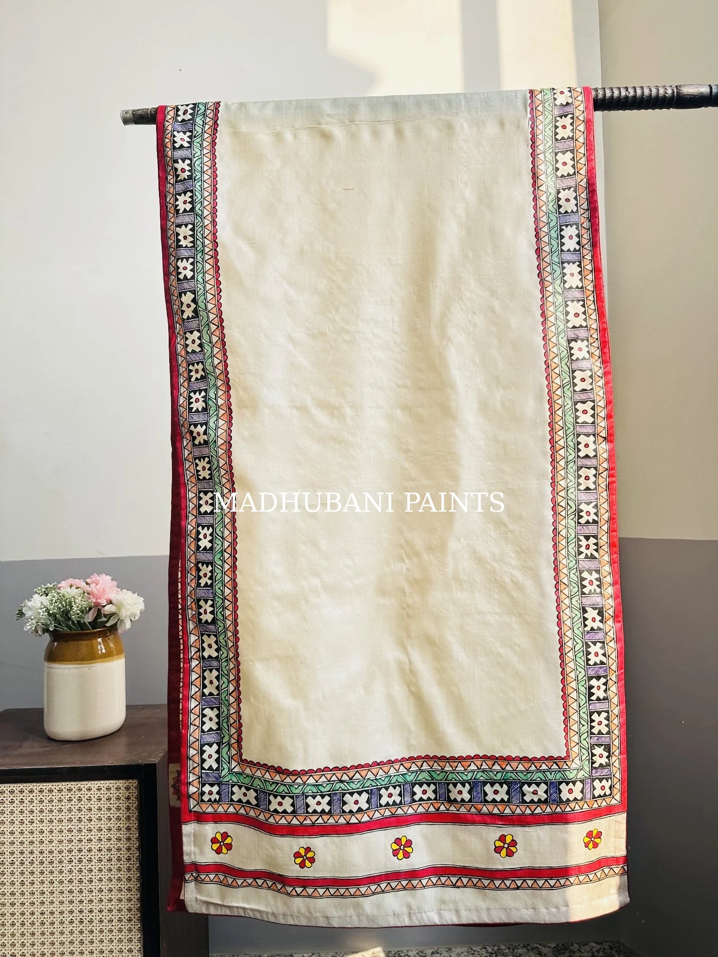 Beige silk stole featuring multi-coloured hand-painted flower motifs and intricate Madhubani-style borders, handcrafted in traditional Mithila painting art.