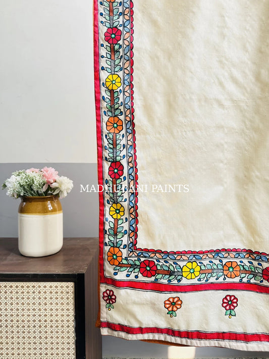 A beige silk stole with colorful hand-painted flower and madhubani borders in madhubani painting art