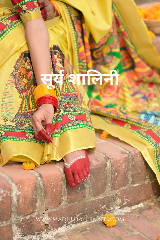 Person wearing a colorful traditional outfit with 'MADHUBANI Painting on it
