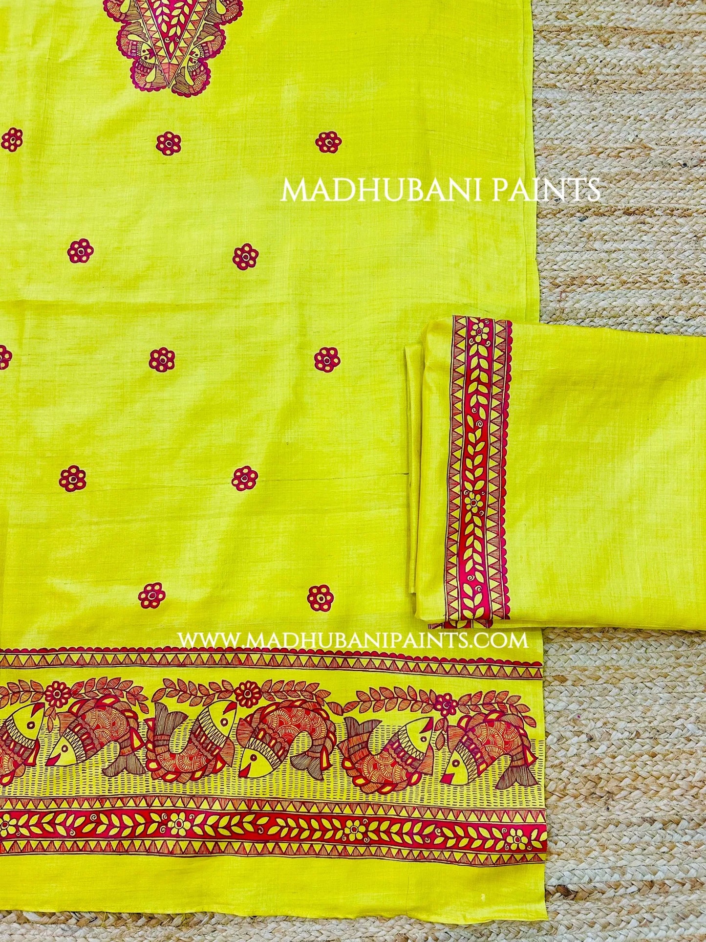 Traditional yellow Madhubani painting kurta set with red fish motifs, floral borders and matching festive accessories.