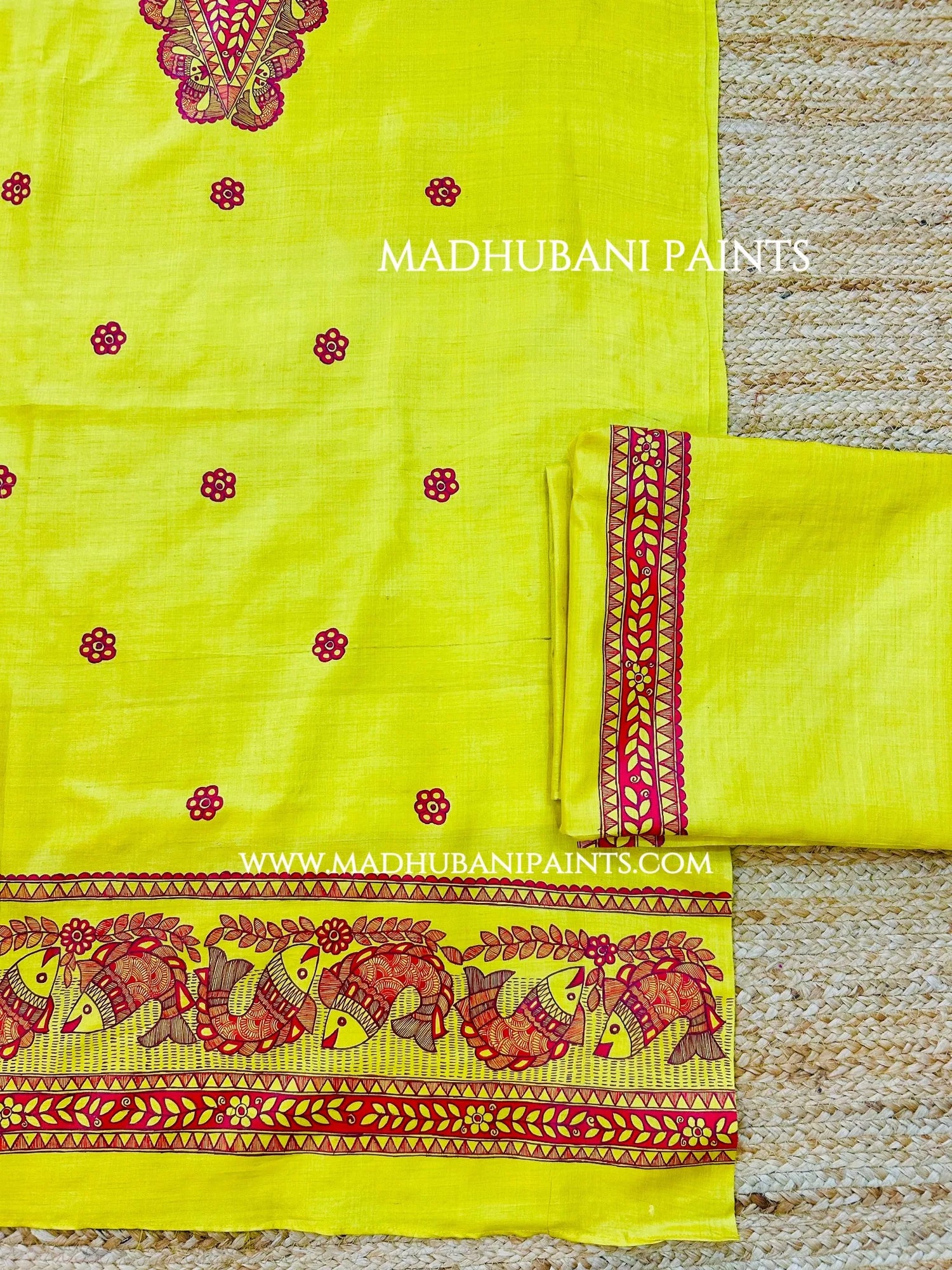 Traditional yellow Madhubani painting kurta set with red fish motifs, floral borders and matching festive accessories.